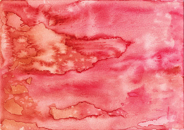 Hand painted watercolor background with flowing abstract effect with colors of coral pink and orange.