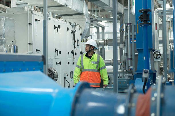 istock Asian Engineer Performing Pipe System Inspection in Modern Industrial Facility 2216295893