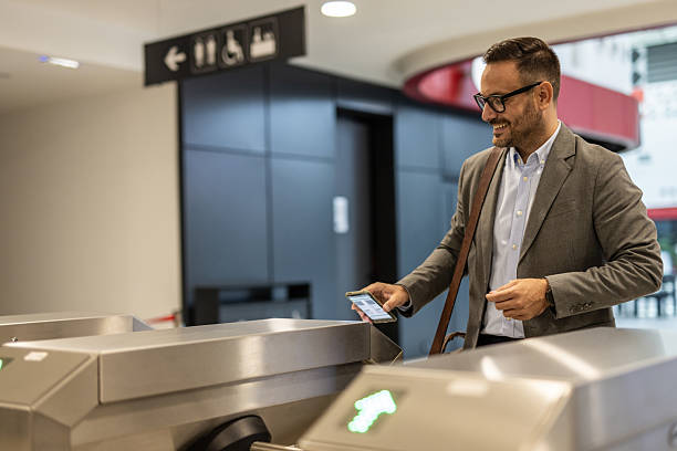 istock Businessman using smartphone to access public transport 2216296037