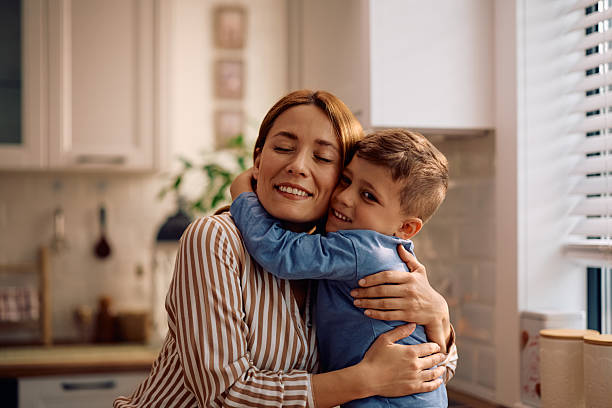 istock Loving boy hugging his mother at home. 2216296459