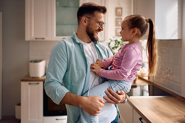 istock Happy man having fun while his small daughter at home. 2216296539