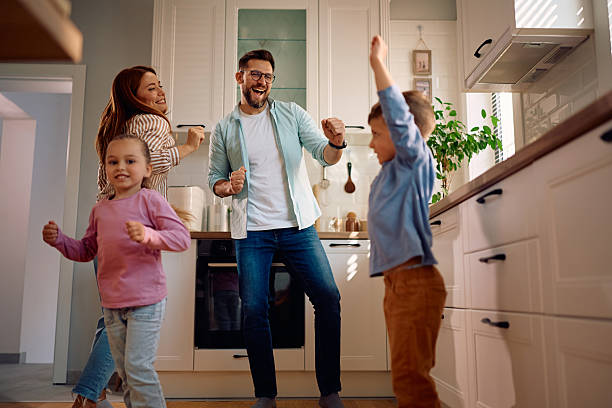 istock Cheerful family dancing while having fun together at home. 2216296677