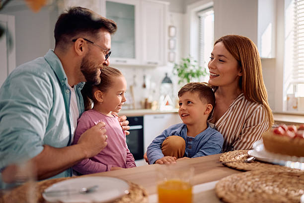 istock Happy family talking while having dessert at dining table. 2216296710