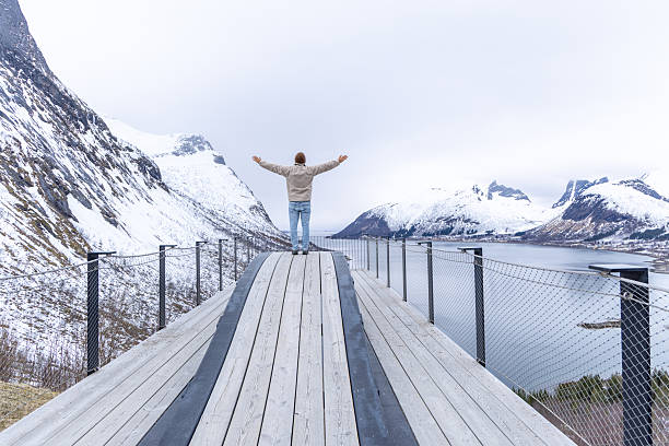 istock Person Embracing Scenic Winter Mountain View on Observation Deck 2216297463