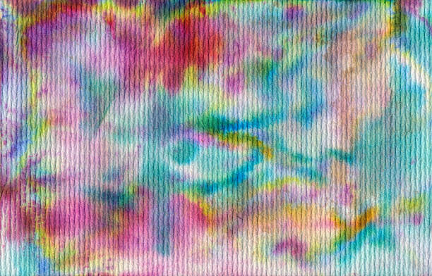 Hand Painted multi-colored watercolor background with shades of blue, pink and yellow. Painted on textured paper.