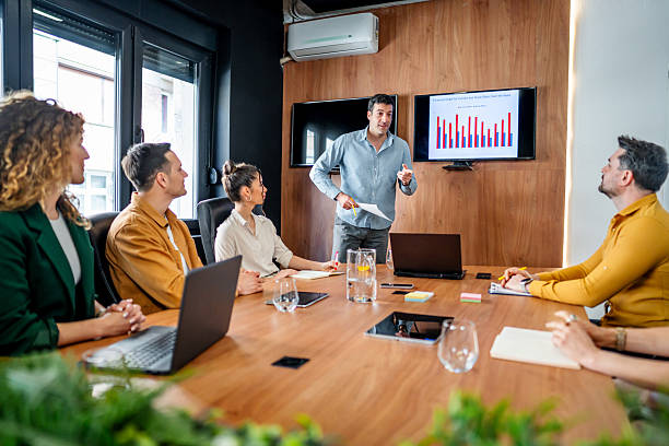 istock Manager leading a business meeting with presentation in conference room 2216299329