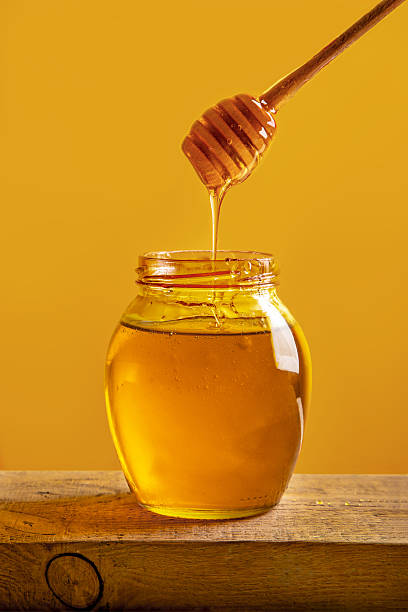 istock Natural honey on yellow background with space for text 2216299410