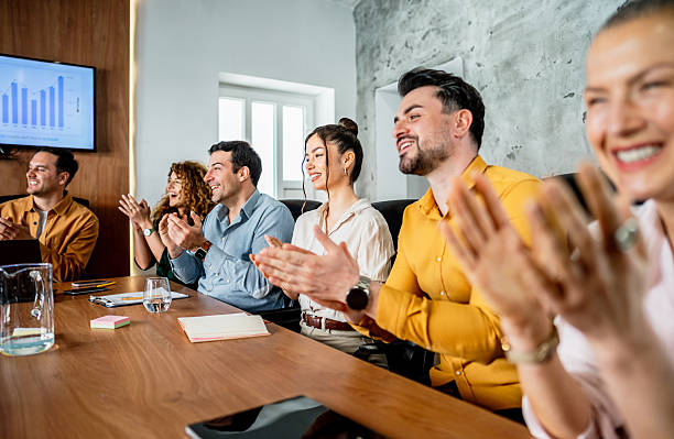 istock Business team clapping hands after successful presentation in meeting room 2216300327