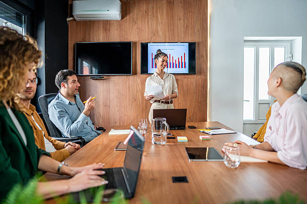 istock Young businesswoman presenting bar graph statistics during a corporate meeting 2216300959