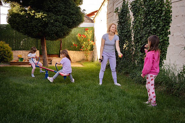 Happy family playing together in backyard during summer afternoon