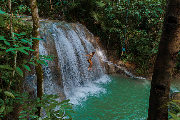 istock Man cliff jumping from waterfall on Cebu island 2216303739