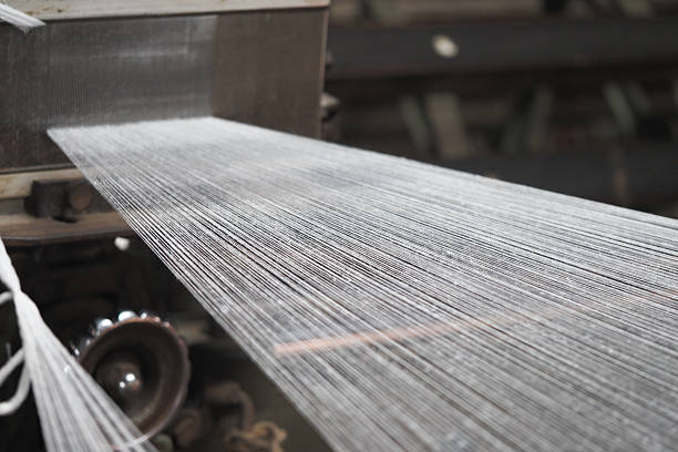 istock Textile factory machine weaving threads in industrial setting 2216303964