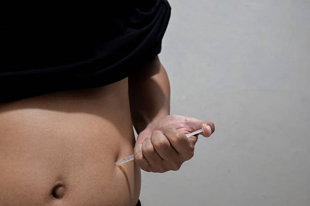 istock A man injecting himself with obesity medication 2216305528