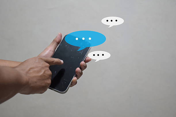istock man hand using smartphone typing, chatting conversation working home in chat box pop up. social media marketing technology concept 2216305546