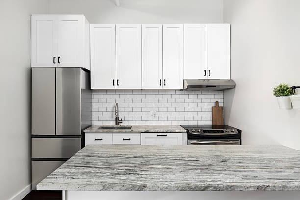 istock A white kitchen with granite countertops and subway tile backsplash. 2216306735