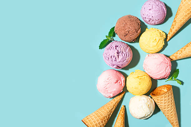 istock Ice cream scoops and waffle cones on blue background 2216306849