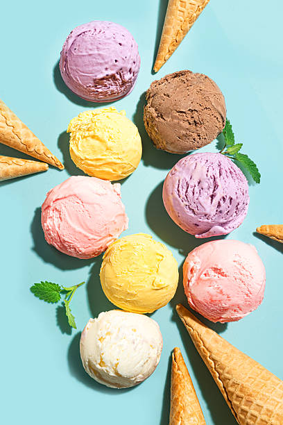 istock Ice cream scoops and waffle cones on blue background 2216306853