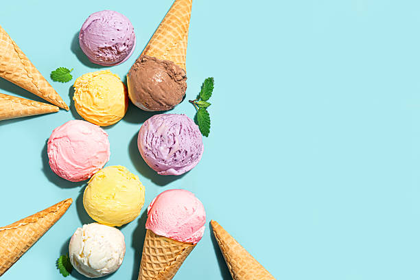 istock Ice cream scoops and waffle cones on blue background 2216306856