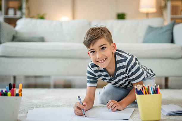 istock One boy drawing at home on the floor 2216308171