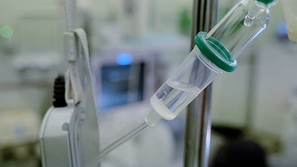 istock Close up medical procedure showing intravenous drip system delivering fluids during surgery, highlighting precision of medical equipment in sterile operating environment 2216308371