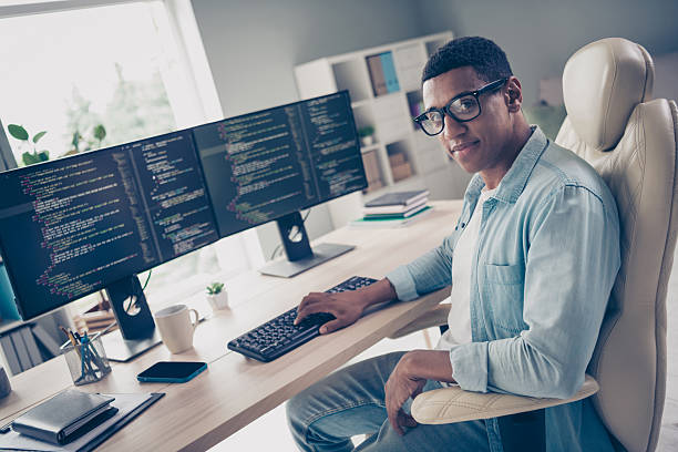 istock Photo of young man self employed introvert programmer working on freelance github website for coders in internet at office background 2216315630