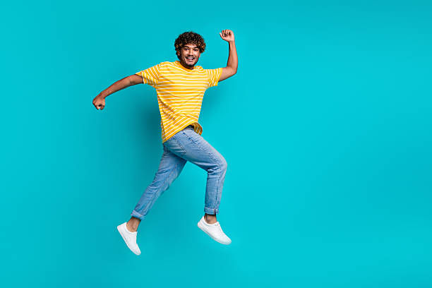 istock Full size profile photo of energetic active guy jump rush empty space ad isolated on teal color background 2216317328