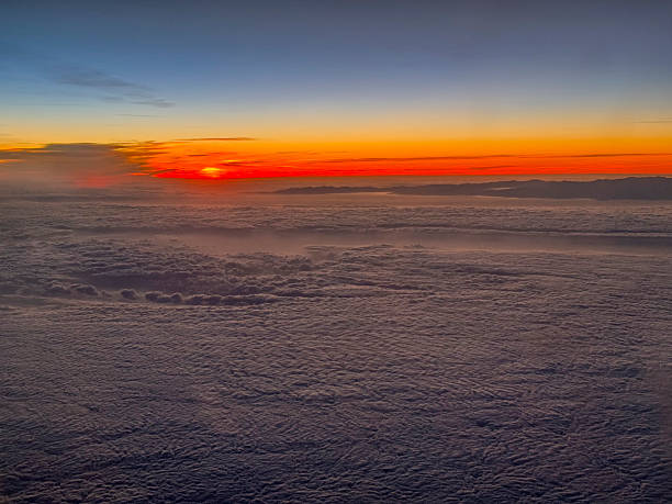 istock A view from an airplane of the sun setting behind the clouds. 2216318665
