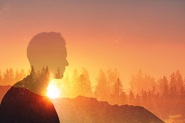 istock Male hiker looking into a beautiful sunset setting.  Man at sunset. 2216319188