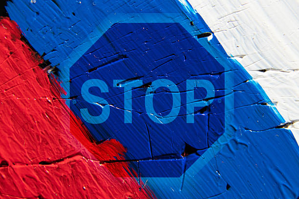 Russian flag painted with paints and stop sign, stop aggression