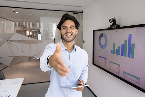 istock Friendly Latino businessman extends his hand for handshake 2216324731