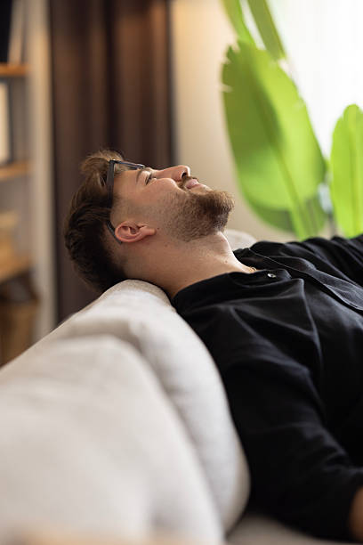 istock Happy dreamy young man relaxing at home 2216326934
