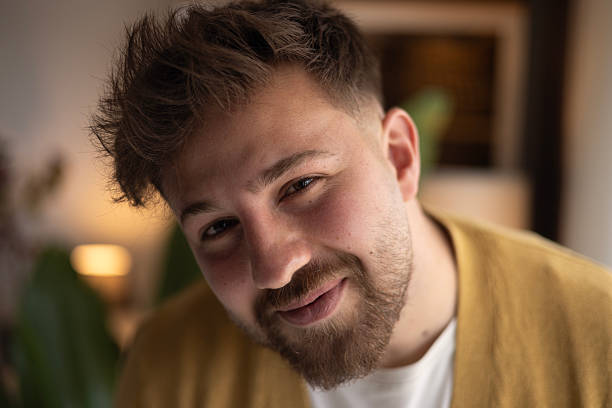 istock A handsome man with a beard is having a pleasant conversation on the phone at home 2216327242
