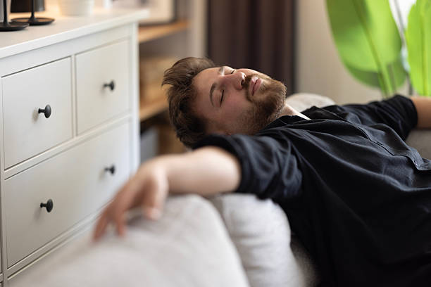 istock Happy dreamy young man relaxing at home 2216329034