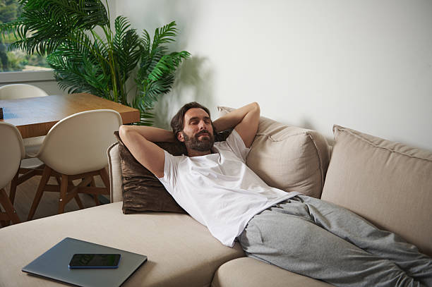 istock Relaxed Man Enjoying Leisure Time at Home in a Comfortable Living Space 2216330057