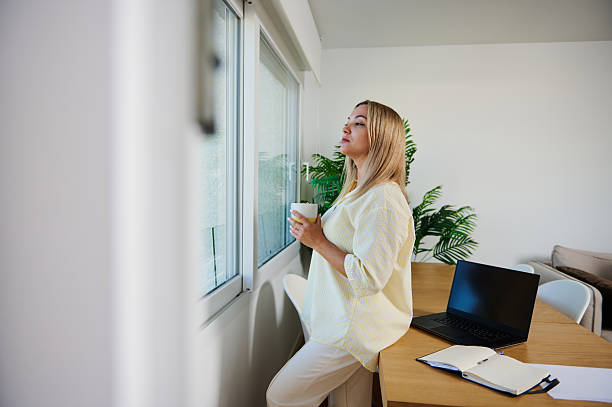 istock Woman Relaxing With Coffee in Minimalist Home Office Setting 2216330398