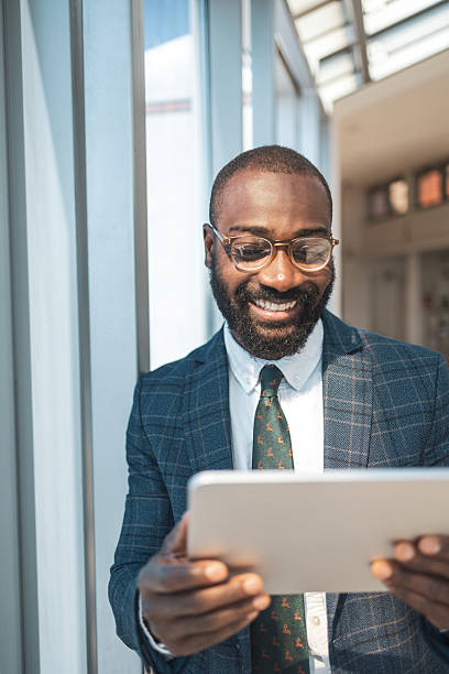 istock Confident professional reading on a tablet in a bright modern office setting 2216331153