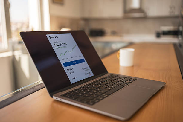 istock Laptop showcasing stock market data in a modern office environment 2216331196