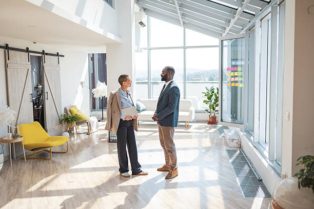 istock Two professionals meeting in a modern bright office with large windows 2216331210