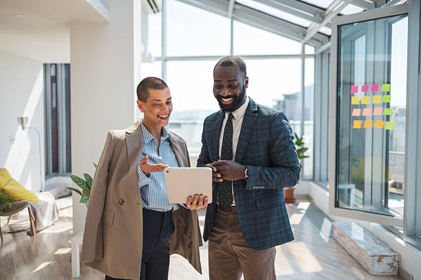 istock Professional coworkers in modern office sharing ideas on a digital tablet 2216331219