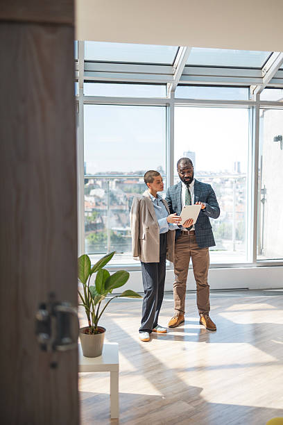 istock Business meeting in sunny office with diverse professionals discussing work documents 2216331235