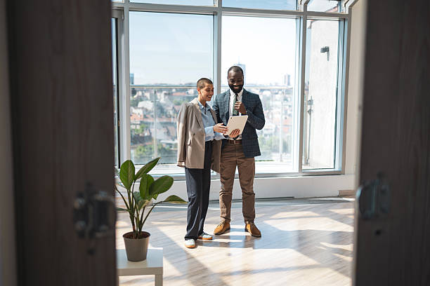 istock Two business professionals collaborating in a modern sunny office space 2216331237