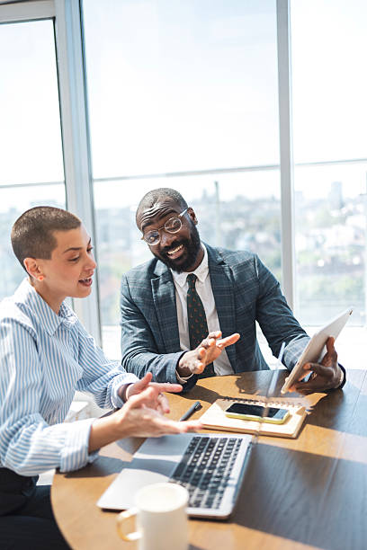 istock Professional colleagues discussing work in a modern office with a bright atmosphere 2216331268