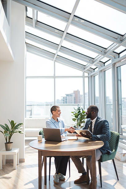 istock Two business professionals collaborating in a bright and modern office setting 2216331276