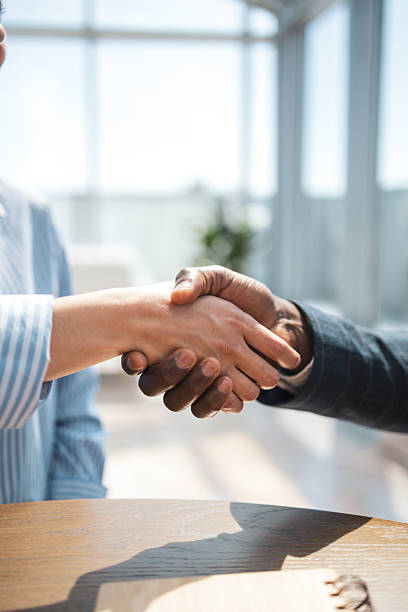 istock Business handshake between colleagues in a modern bright office setting 2216331280