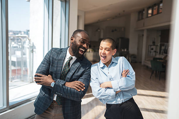 istock Two colleagues sharing a laugh in a modern bright office environment 2216331287