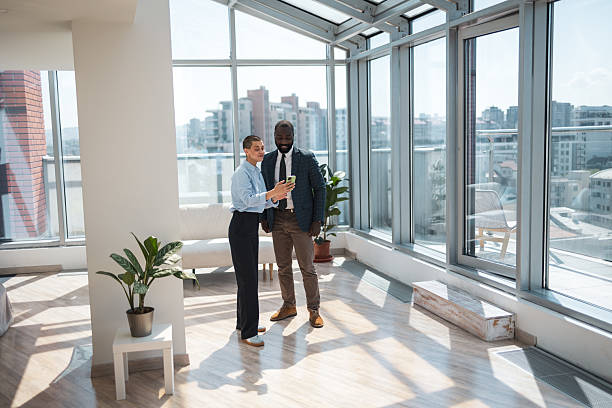 istock Business professionals discussing work in a sunny and modern office setting 2216331289