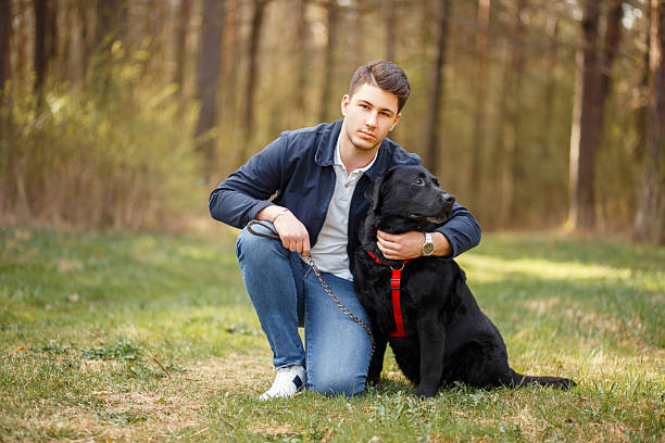 istock Man with a dog walks in nature on a spring day 2216333038