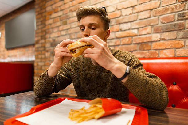 Man eating fast food in a cafe