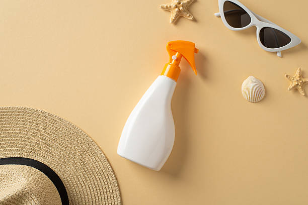 istock Sunscreen bottle surrounded by beach accessories including a hat, shells, starfish, and sunglasses 2216334888