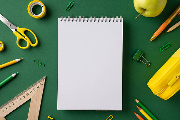 istock Notebook surrounded by colorful stationery items including pencils and scissors, evoking creativity 2216334899